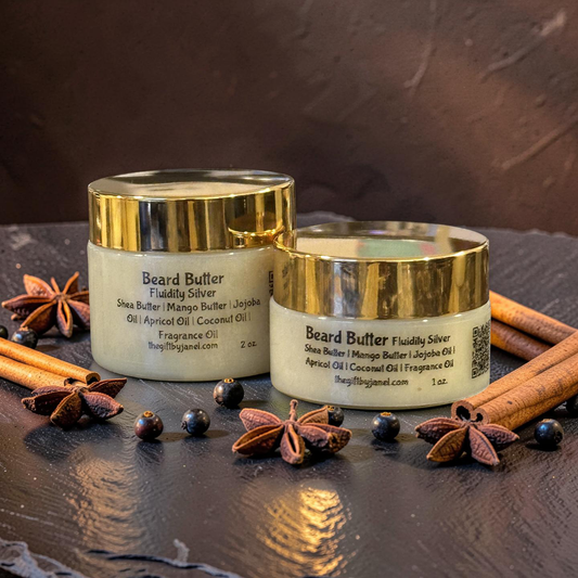 Two jars of beard butter with gold lids on a dark surface with spices.