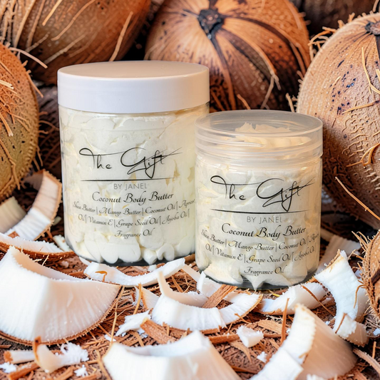 Two containers of coconut body butter surrounded by coconuts and coconut shavings.