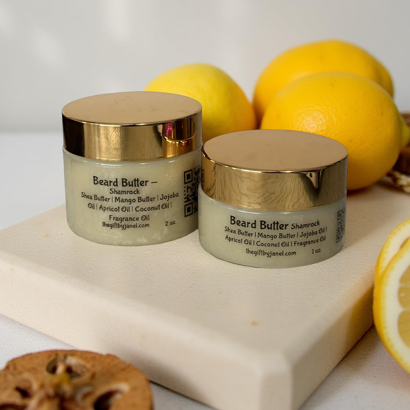 Two jars of beard butter with lemons on a white surface