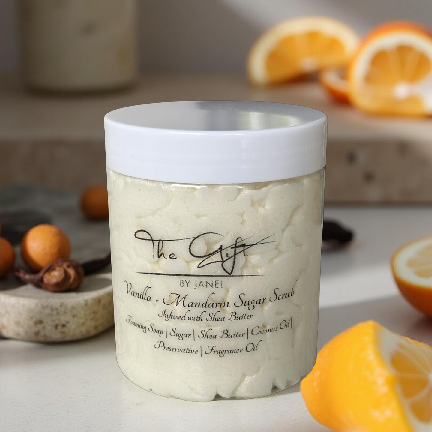 Jar of Vanilla Mandarin Sugar Scrub with oranges and spices on a neutral background