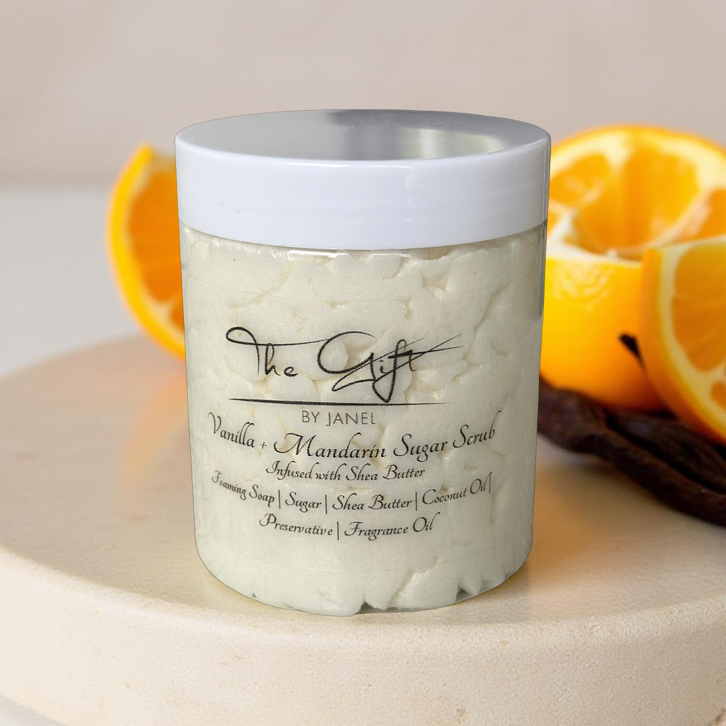 Jar of Vanilla Mandarin Sugar Scrub with oranges in the background