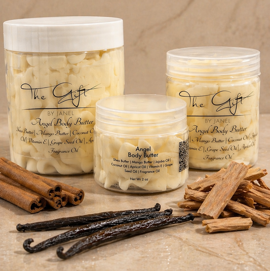 Three jars of 'Angel Body Butter' with vanilla beans and cinnamon sticks on a beige marble surface.