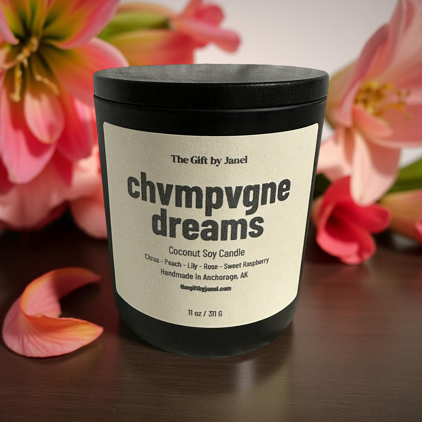 Coconut soy candle labeled 'chvmpvgne dreams' with pink flowers in the background