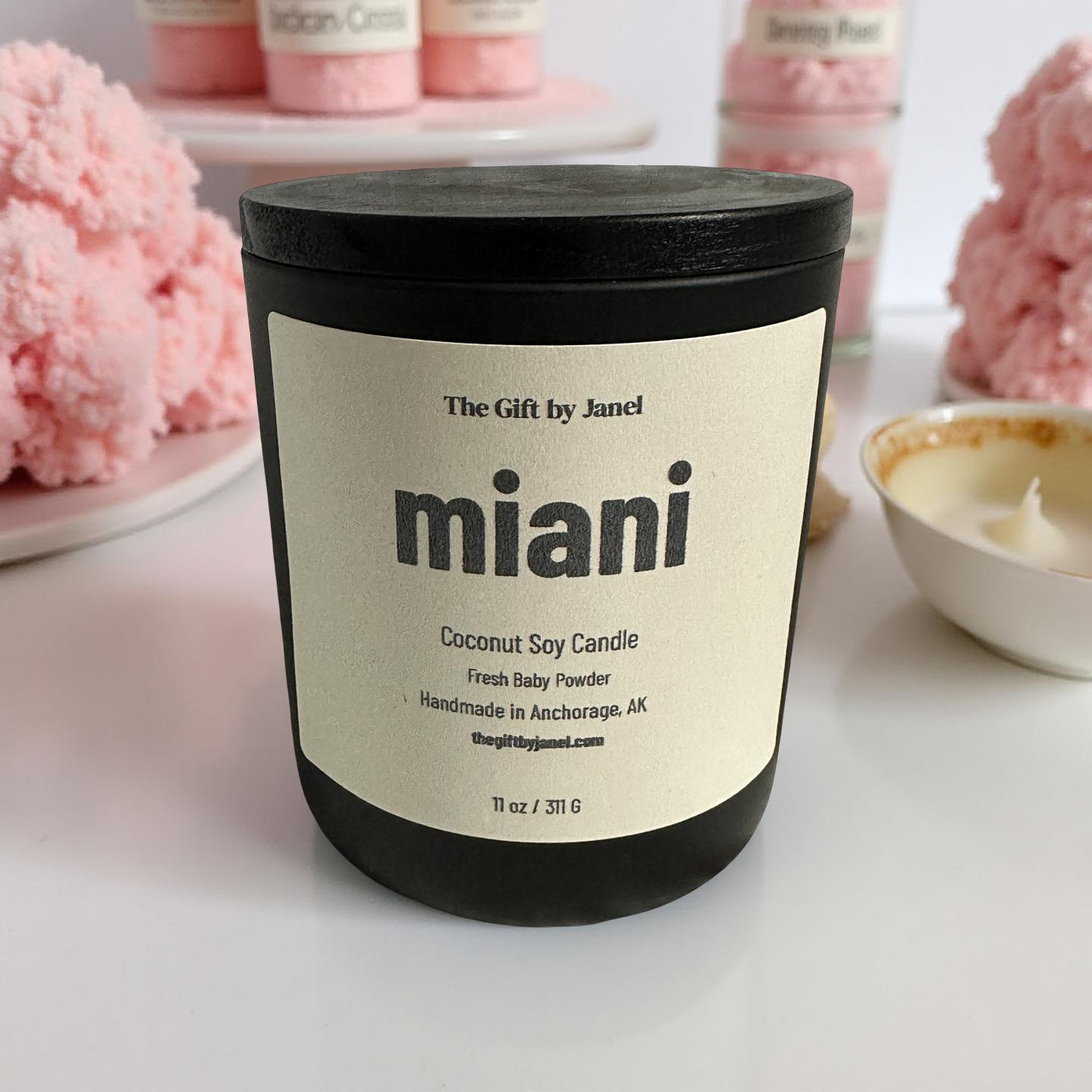 Candle labeled 'miani' with decorative pink flowers in the background