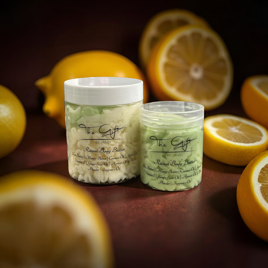 Two jars of body butter with lemons in the background on a dark surface