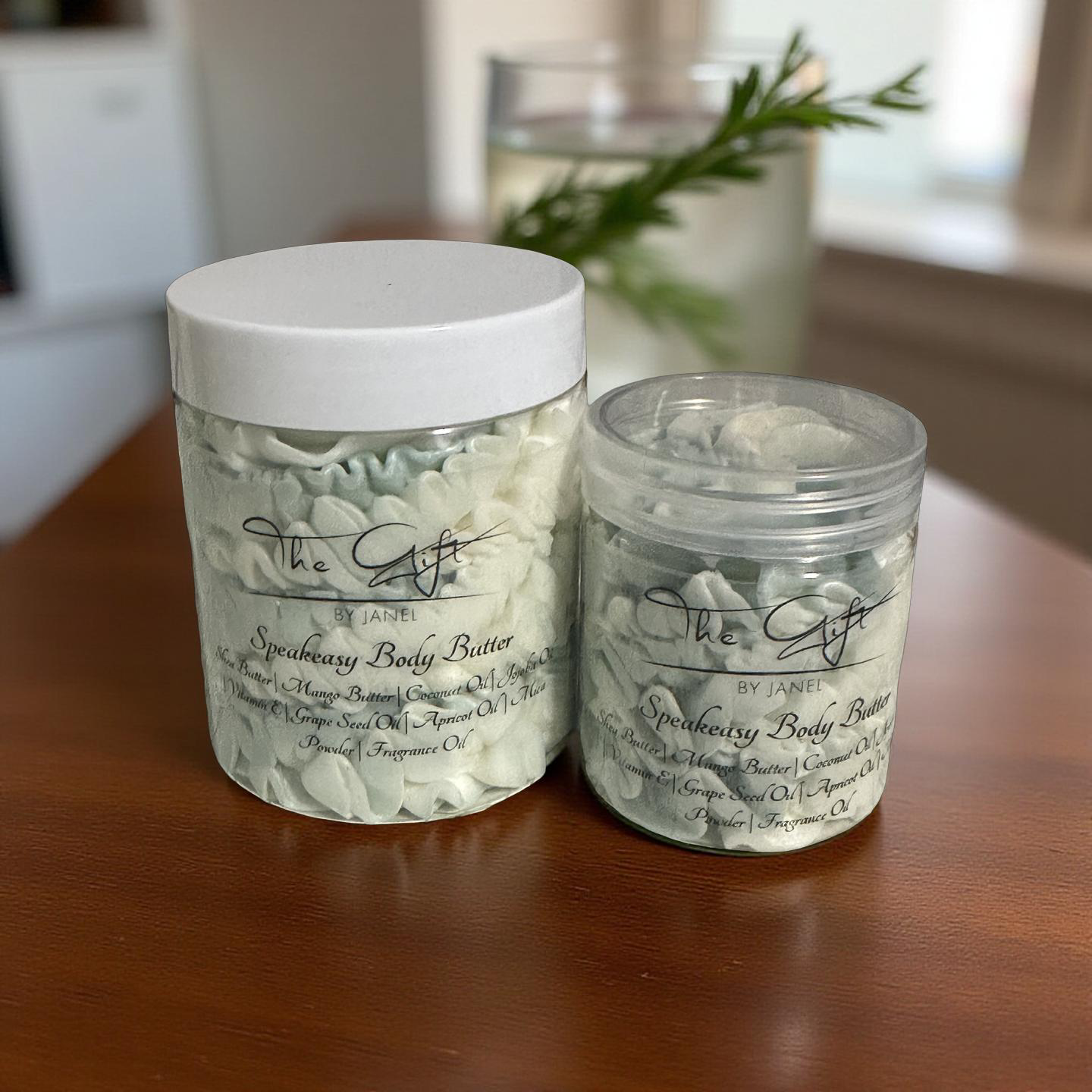Two jars of Speakeasy Body Butter on a wooden surface with a blurred background
