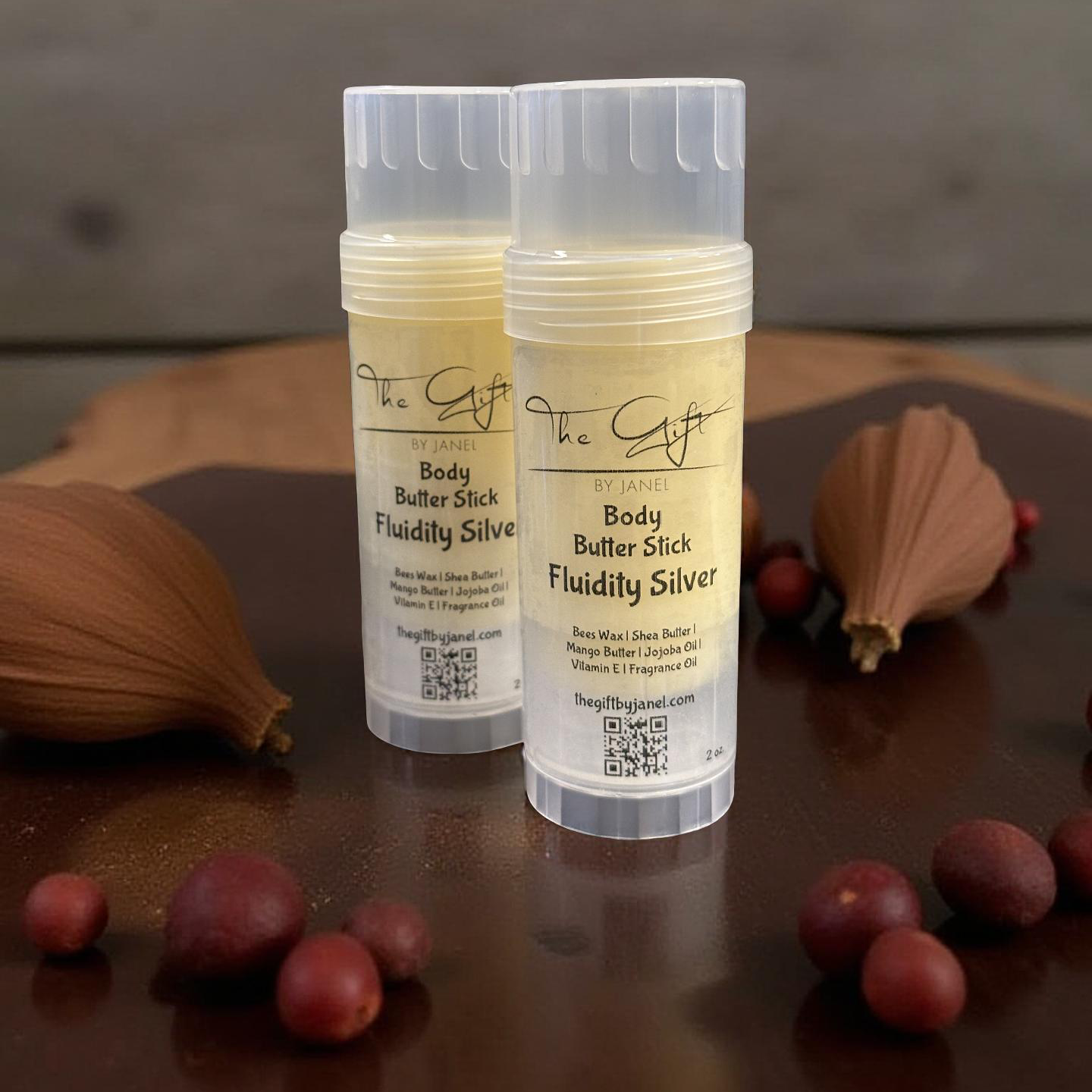 Two body butter sticks with visible branding on a wooden surface.