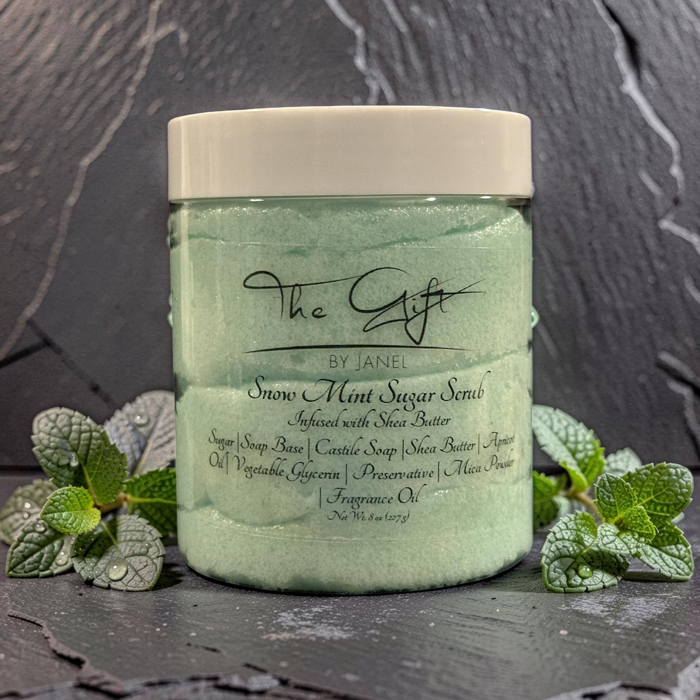 Green jar of snow mint sugar scrub with mint leaves on a dark background