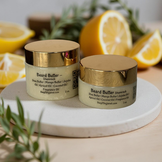 Two jars of beard butter on a marble tray with lemons and greenery in the background