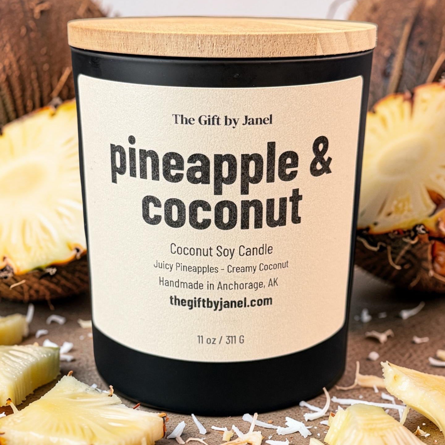 Candle labeled 'Pineapple & Coconut' with a wooden lid, surrounded by pineapple slices on a neutral background.